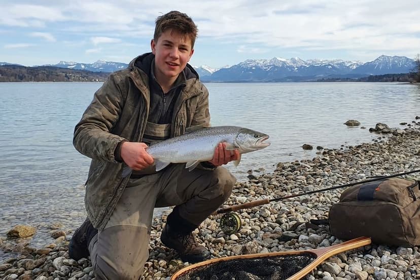 Angler mit Spinnrute beim Seeforellenangeln am Ammersee im Frühjahr